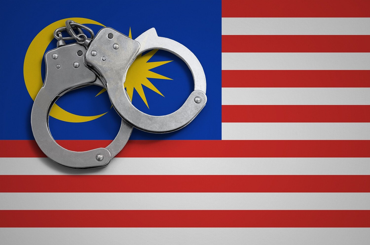 マレーシアの国旗と手錠